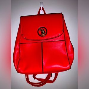 Red backpack with unique metal Ralph Lauren pendent